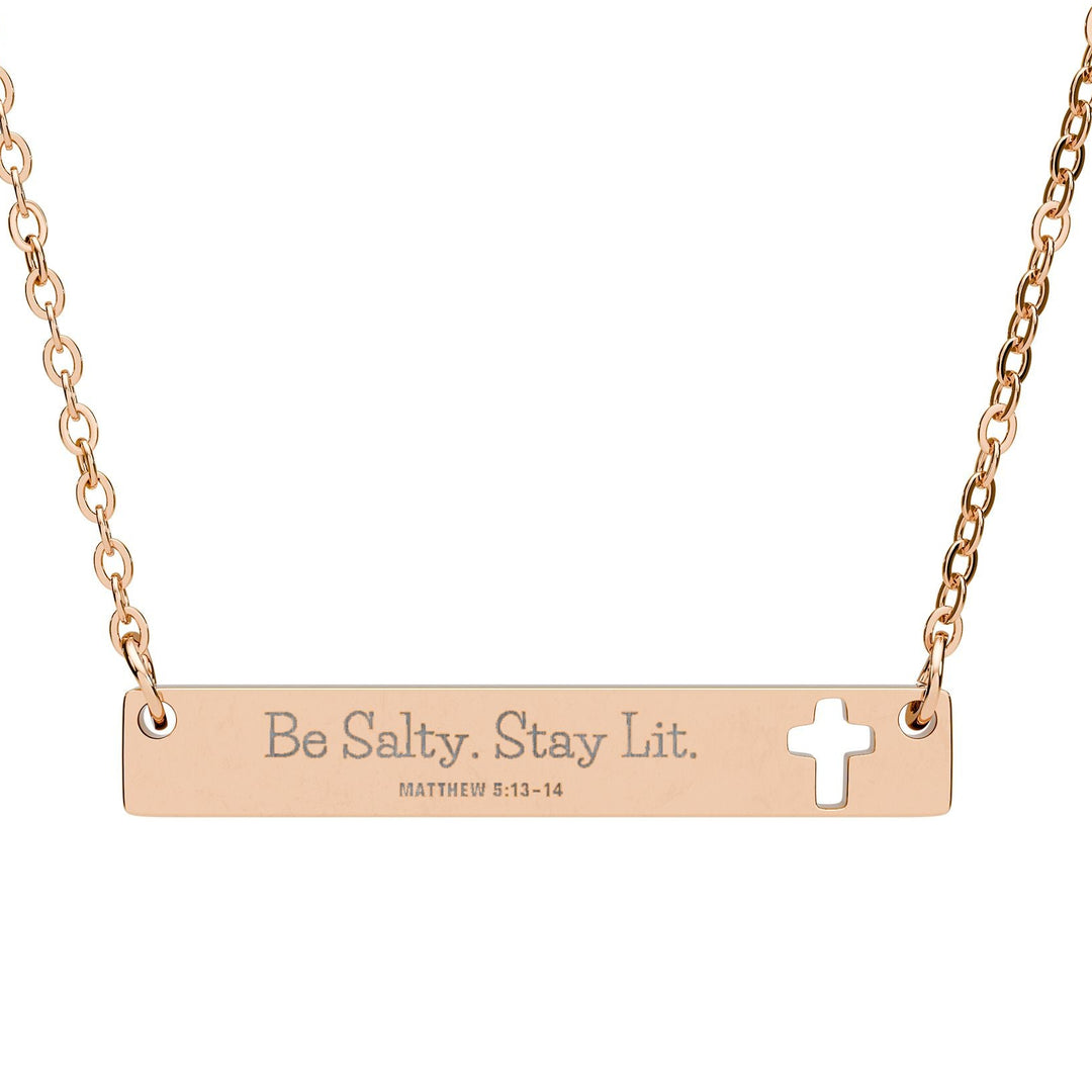 Rose gold necklace with bar pendant and cross, featuring 'Be Salty. Stay Lit.' text.